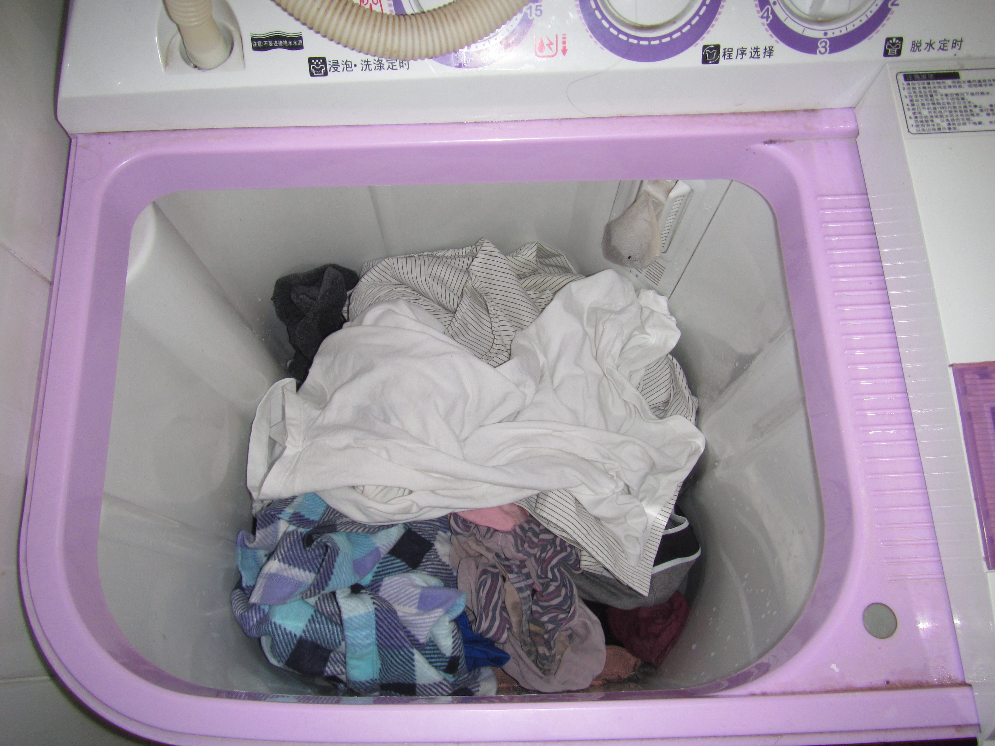 Step 5: Round up your clothes and throw them in the washing machine. Make sure that you don't throw in too much because the blue circle will only spin with a key amount of clothing in the washing machine