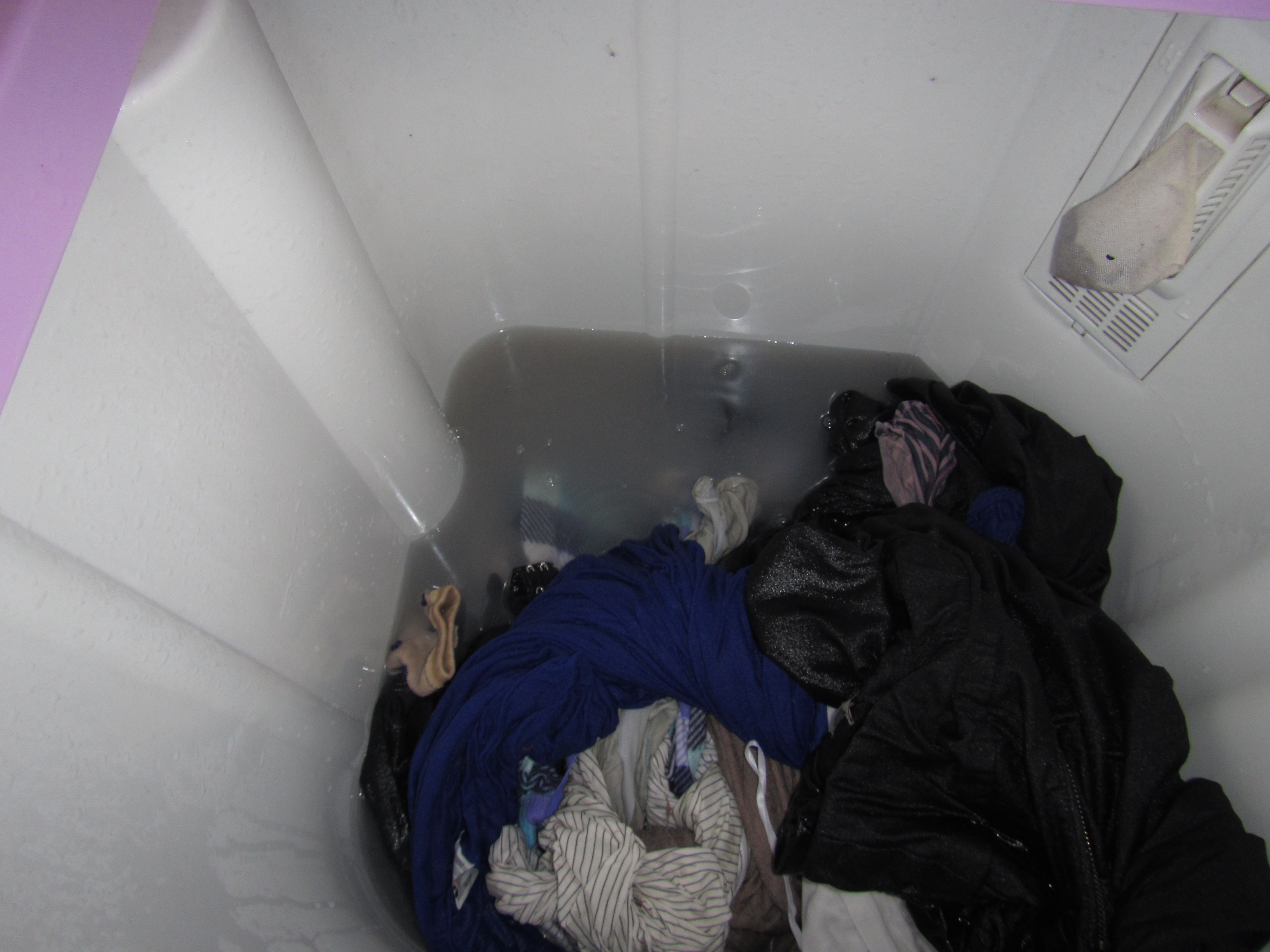Step 8: After 35 minutes (25 of which are spent just allowing the clothes to soak between clockwise or counterclockwise spins), your clothes have been 'cleaned'. This is what the water looks like. China is very dusty by the way...