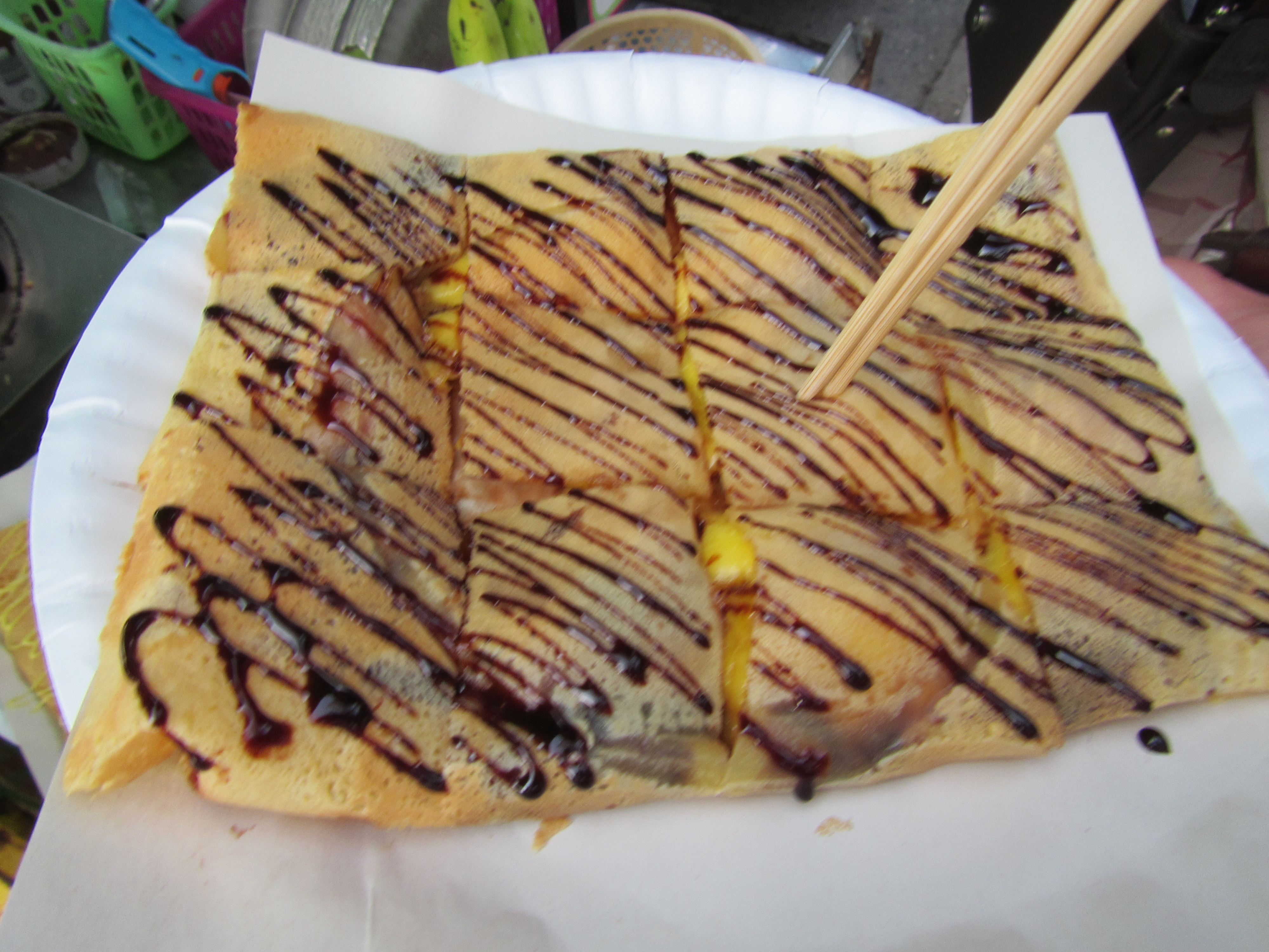 Street food crepes!  Made fresh on the grill with mango and chocolate syrup!